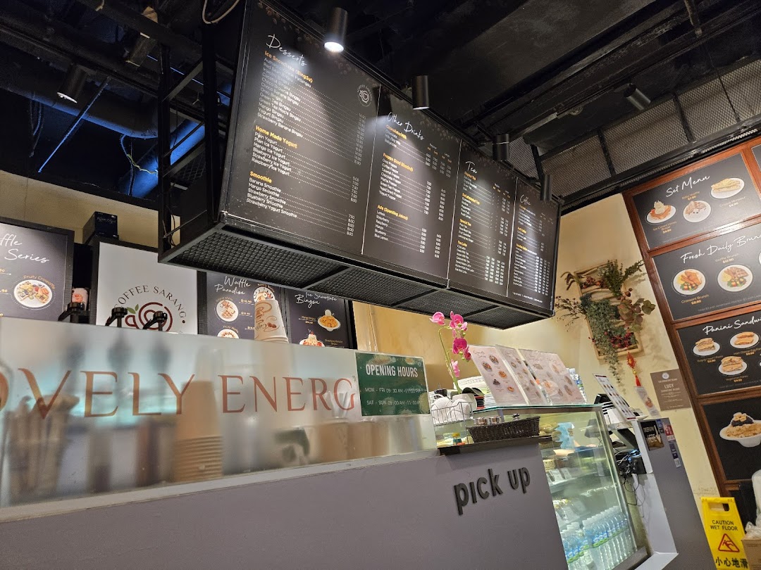 Coffee shop interior with hanging menus, counter, and display case.