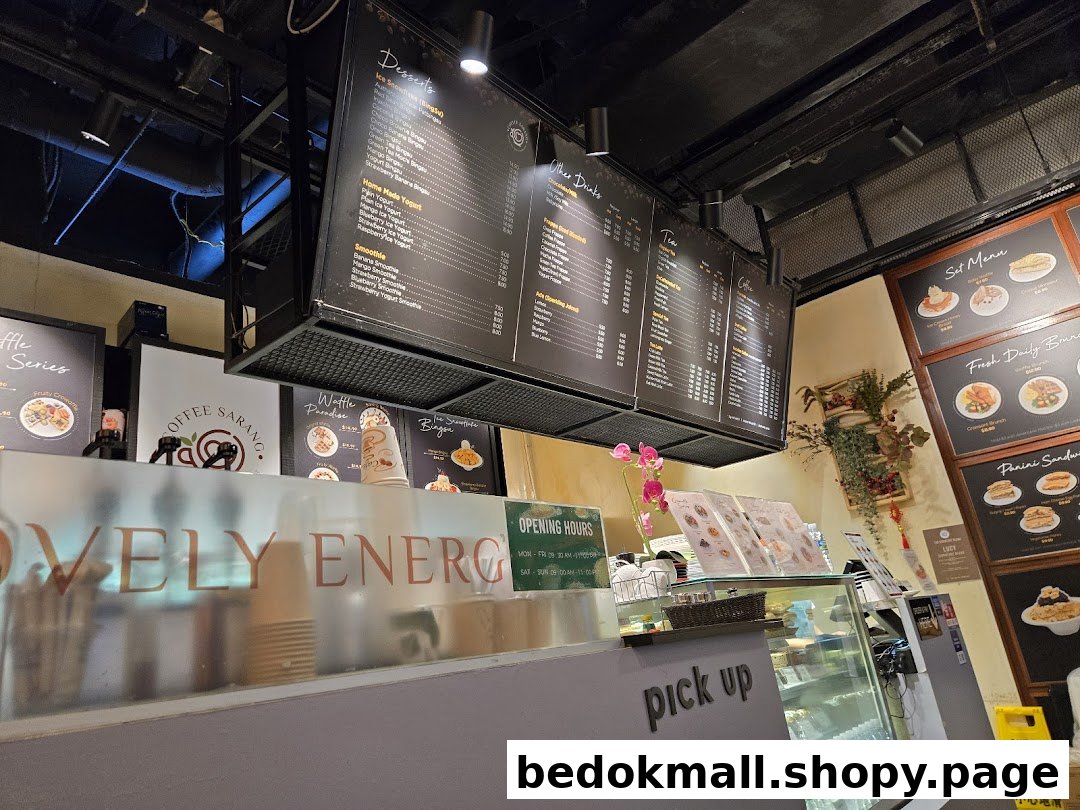 Coffee shop interior with hanging menus, counter, and display case.
