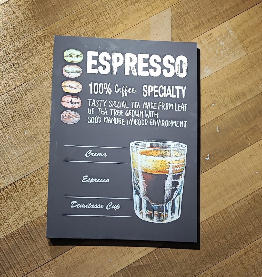 Black sign describing espresso with an illustration and its layers.