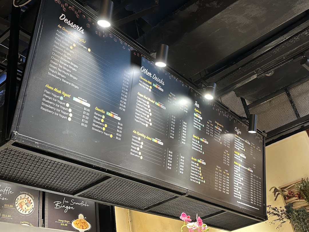 Large menu board displaying desserts, drinks, and coffee options with prices.