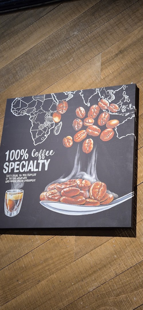 A sign with coffee beans, a map, and text about coffee specialty.