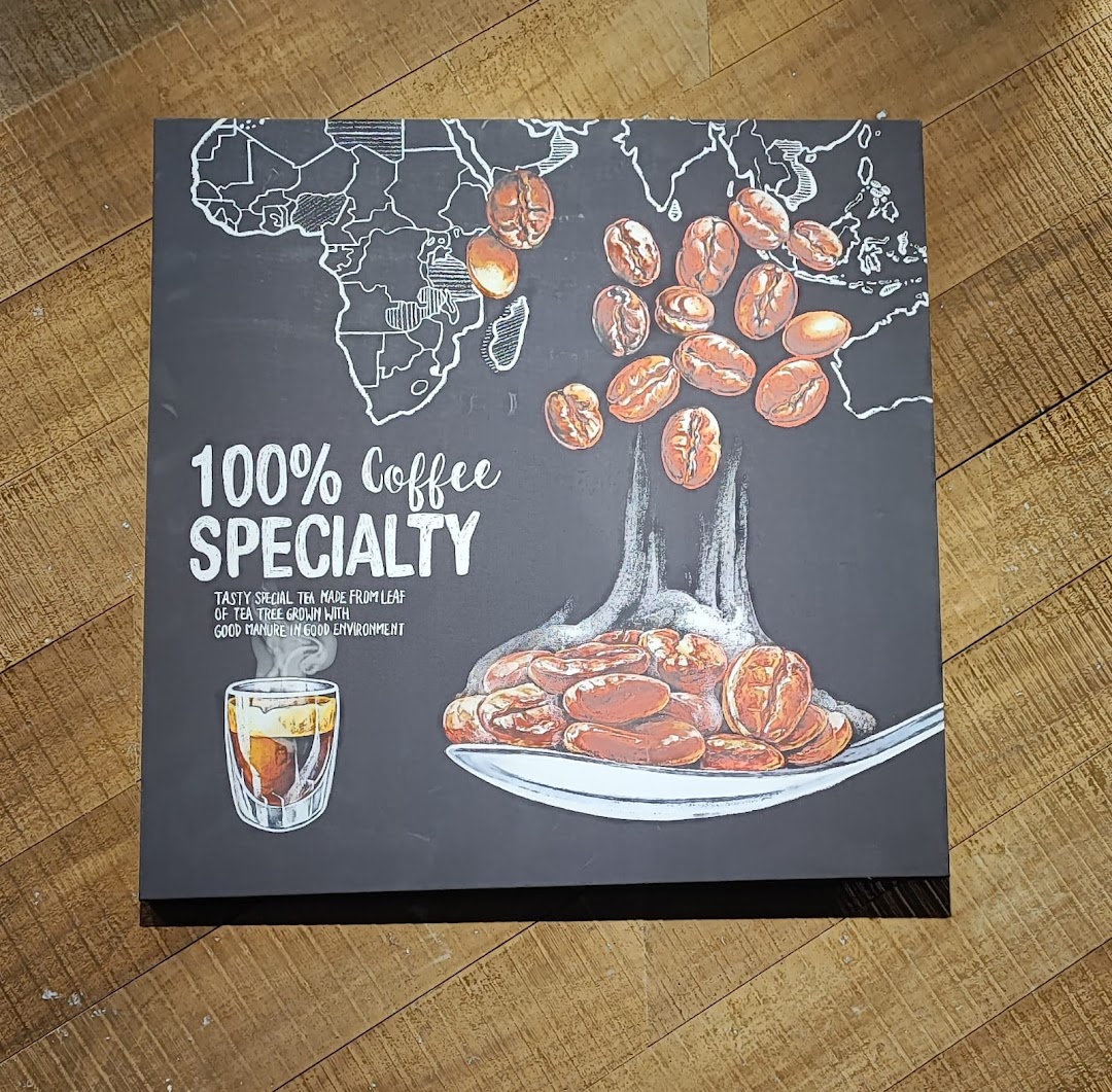 Sign promoting coffee specialty with coffee beans and a drink illustration.