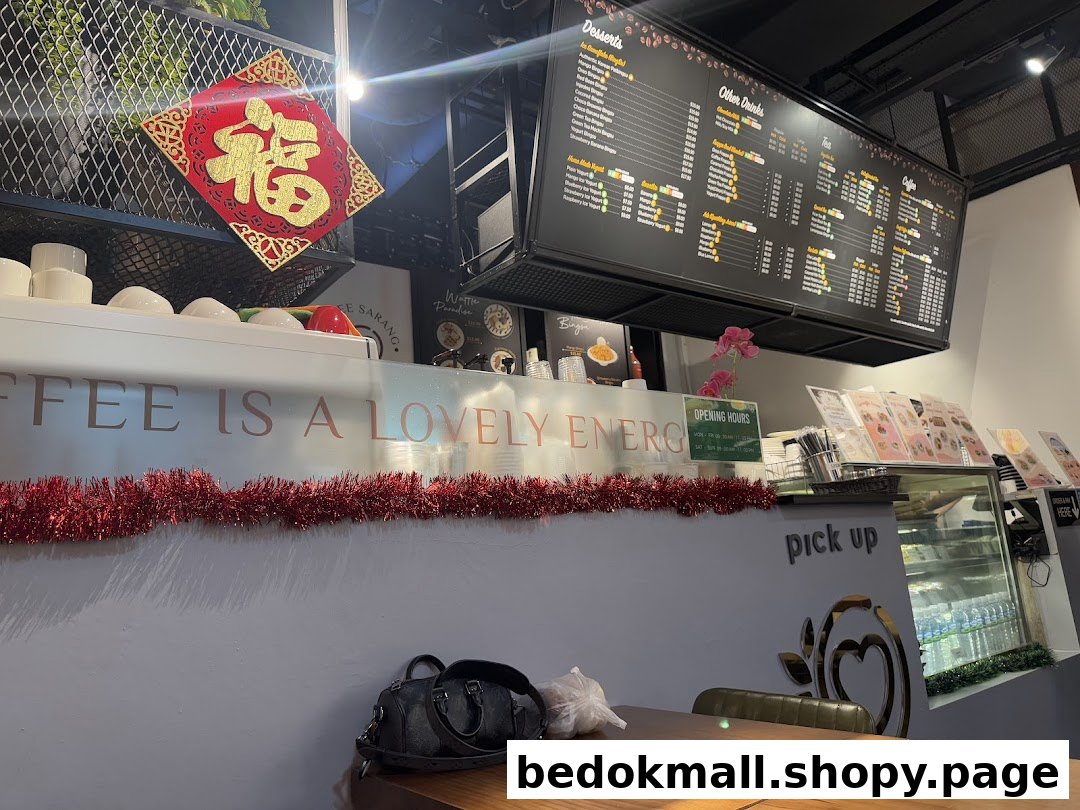 Interior view of a coffee shop with a large menu board and counter.
