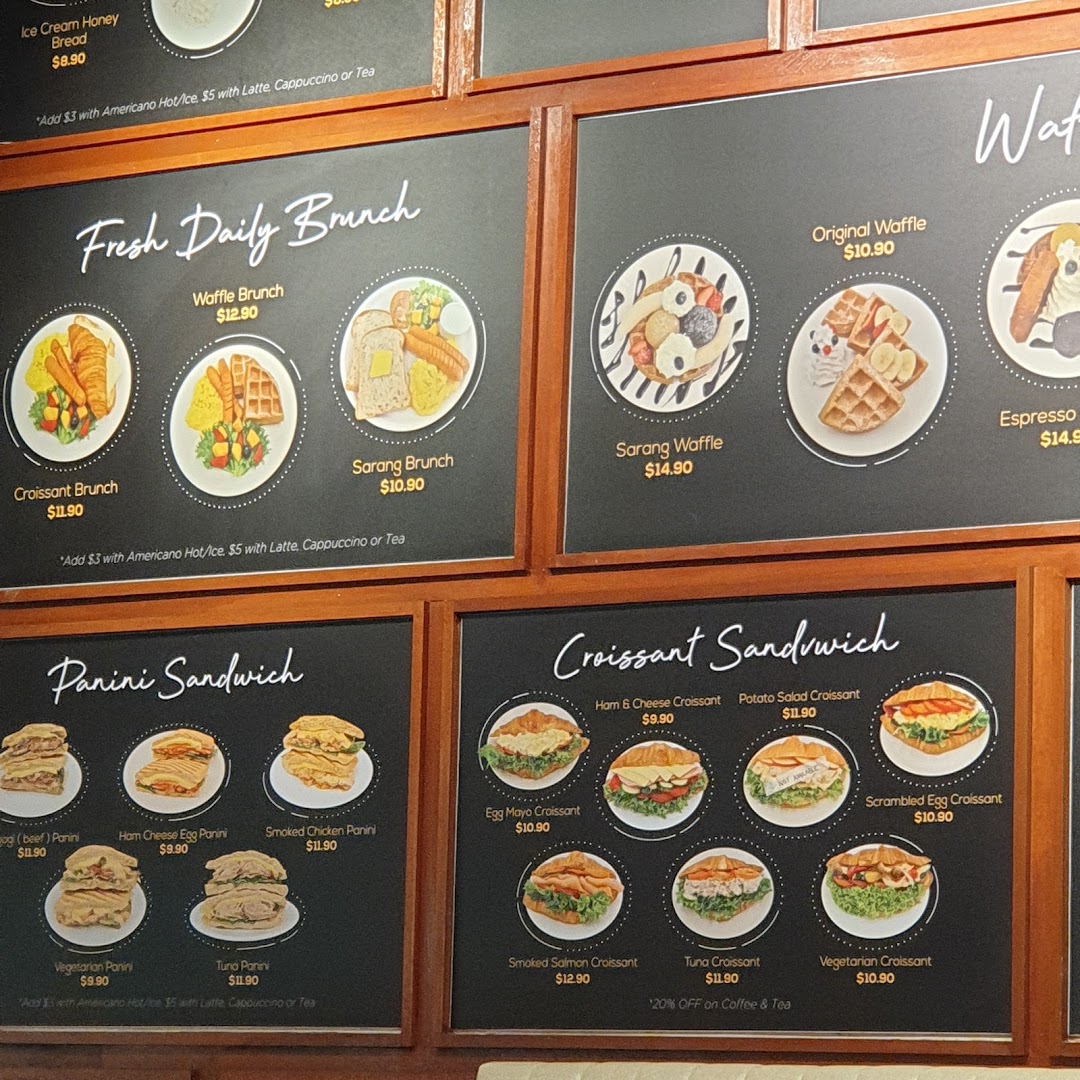Multiple menu boards display various food items like brunch, waffles, and sandwiches with prices.