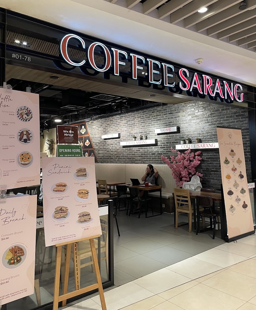 Entrance of COFFEE SARANG coffee shop with menus outside and interior visible.