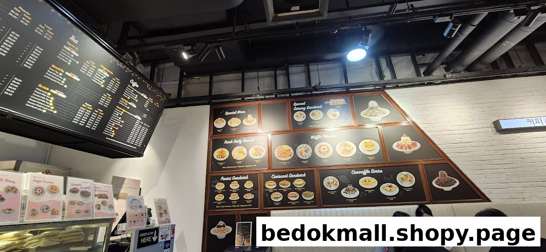 Interior view of a coffee shop with large menu boards and customers.