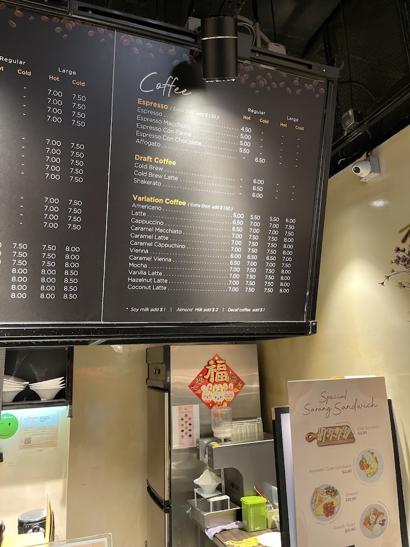 A large coffee menu board and a smaller sandwich menu in a shop.