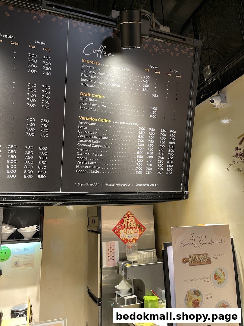 A large coffee menu board and a smaller sandwich menu in a shop.