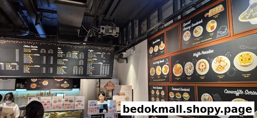 Interior of a coffee shop with large menu boards displaying food and drinks.