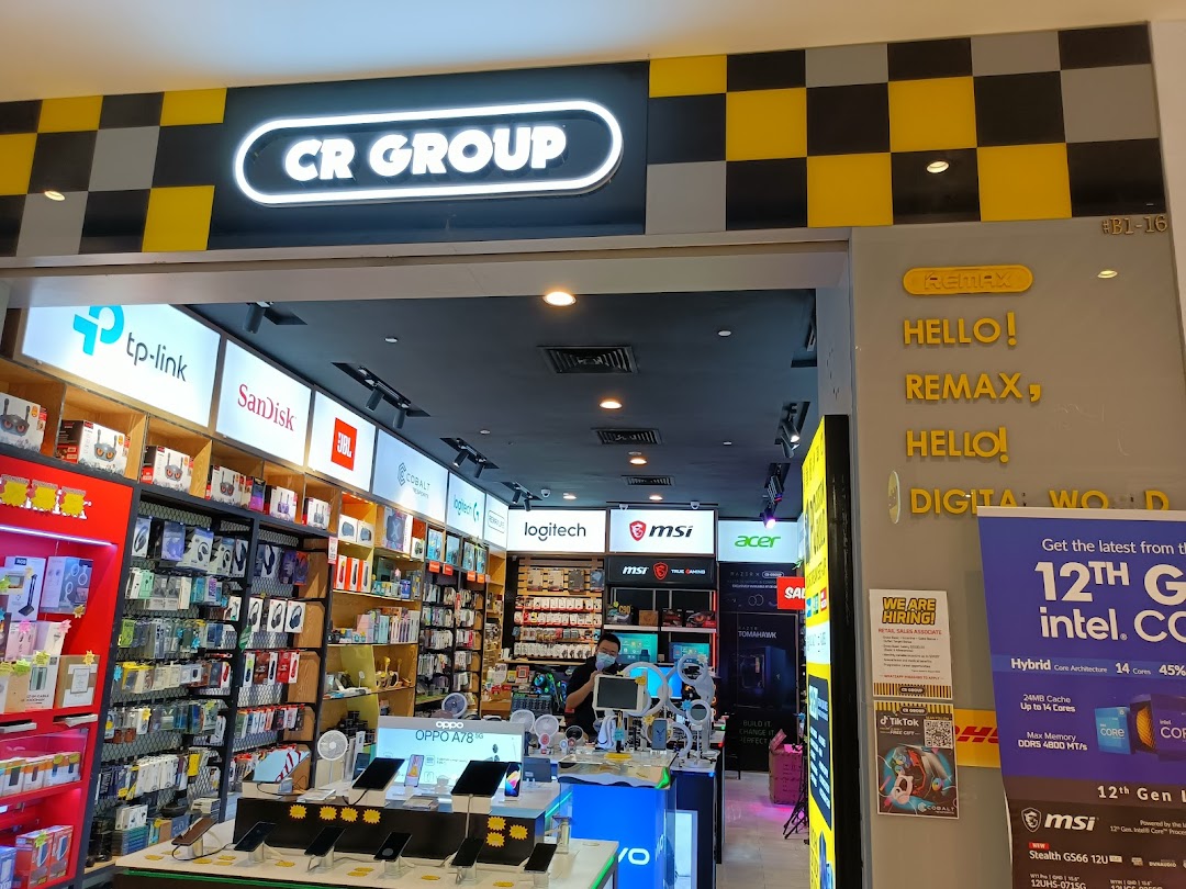 Entrance of an electronics shop with products and staff visible inside.