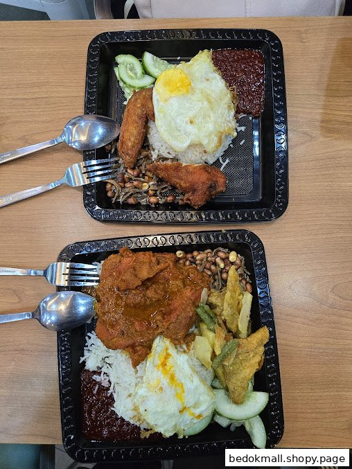 Two plates of Nasi Lemak with chicken, egg, and various toppings.