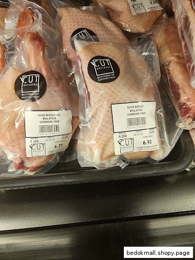 Packaged duck meat products with labels displayed in a retail chiller.