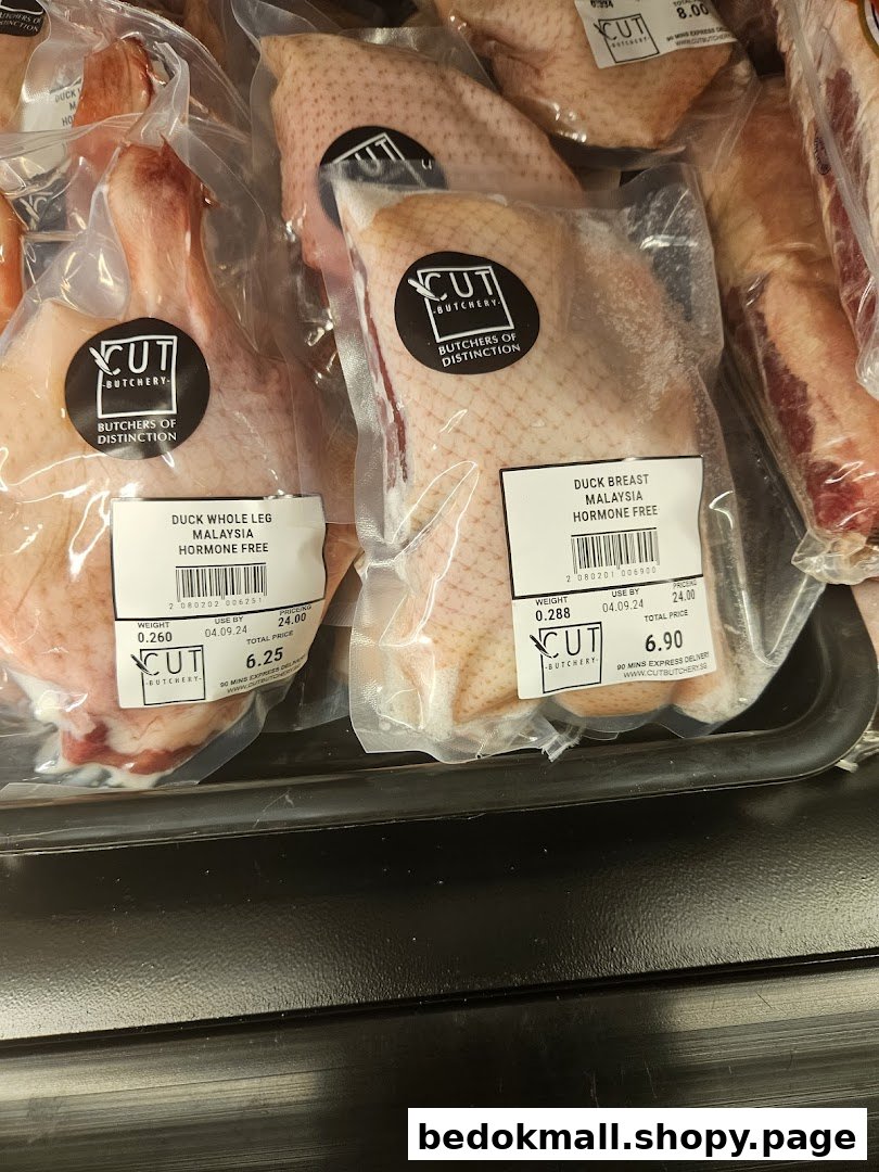 Packaged duck meat products with labels and prices in a display.