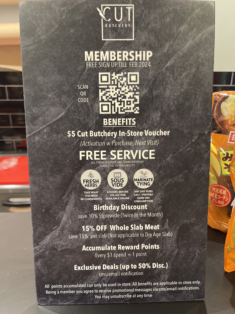 Sign detailing membership benefits and services for Cut Butchery.