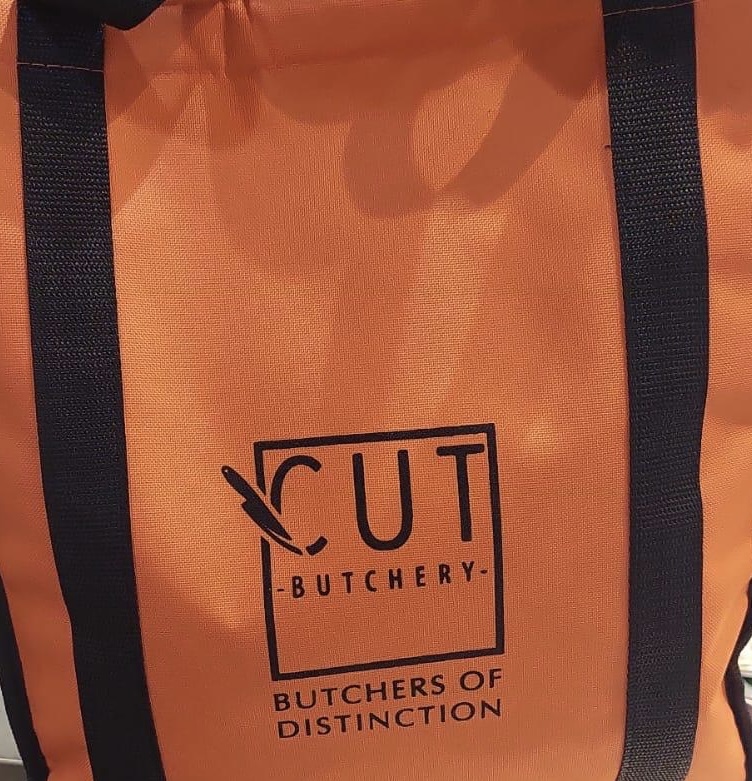 Orange reusable bag with the 'Cut Butchery' logo prominently displayed.
