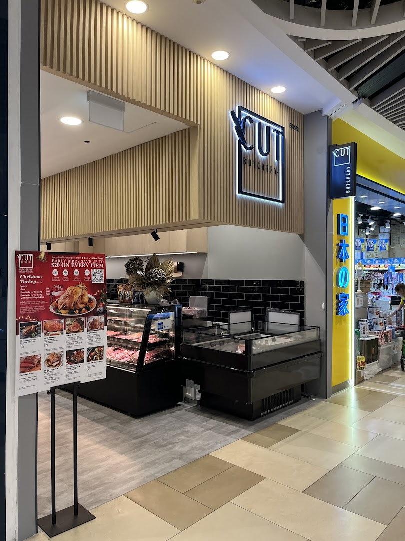Exterior view of Cut Butchery showing entrance, signage, and product displays.