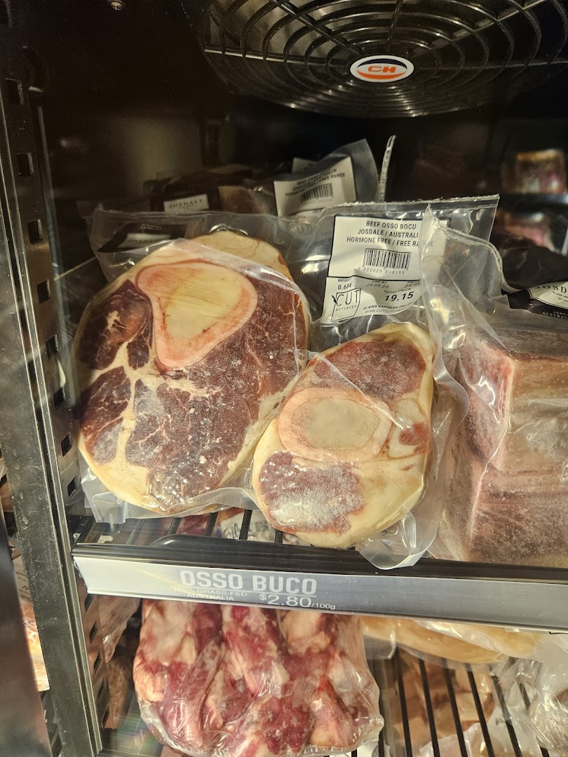 Packaged Osso Buco meat displayed in a refrigerated case with price labels.