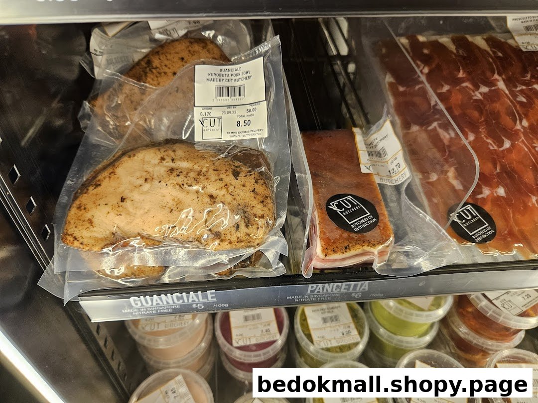 Packaged meat products and sauces displayed in a refrigerated case.