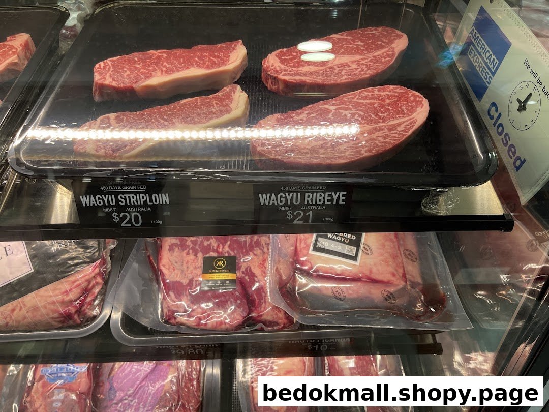 Refrigerated display case showing various cuts of Wagyu beef with prices.