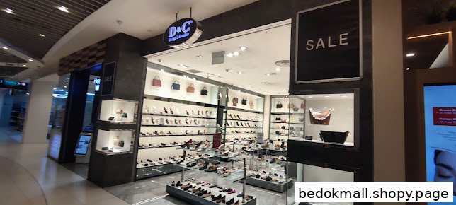 Exterior view of a shoe and handbag shop with a 'SALE' sign.