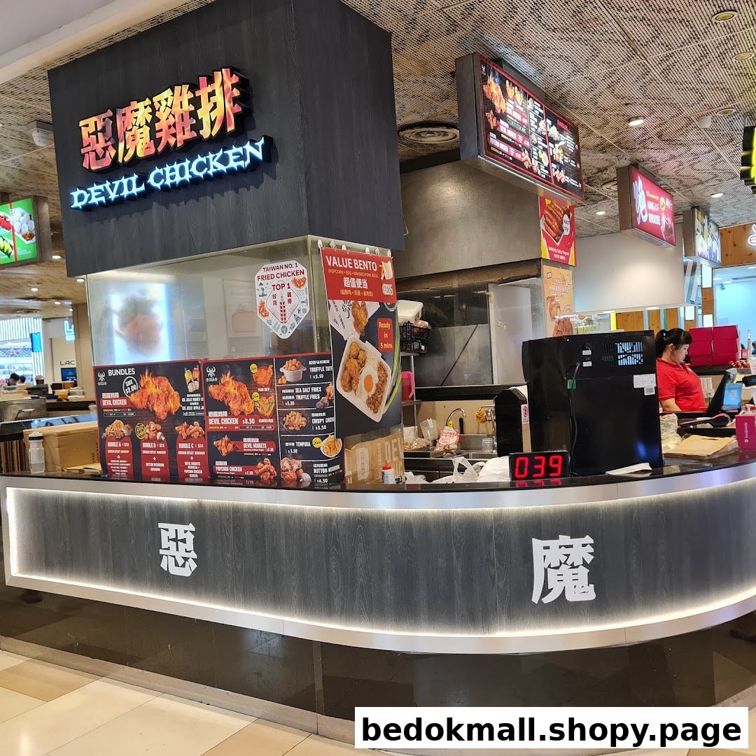 Interior view of a food stall counter with menu boards and staff.