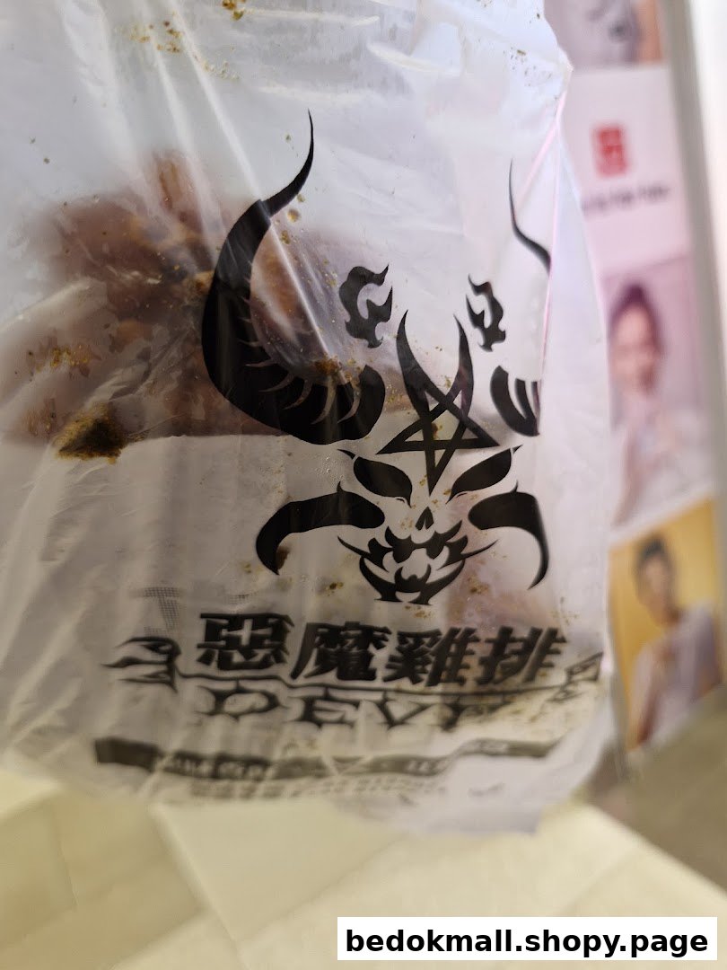Close-up of a clear plastic bag with a devil logo, containing food.