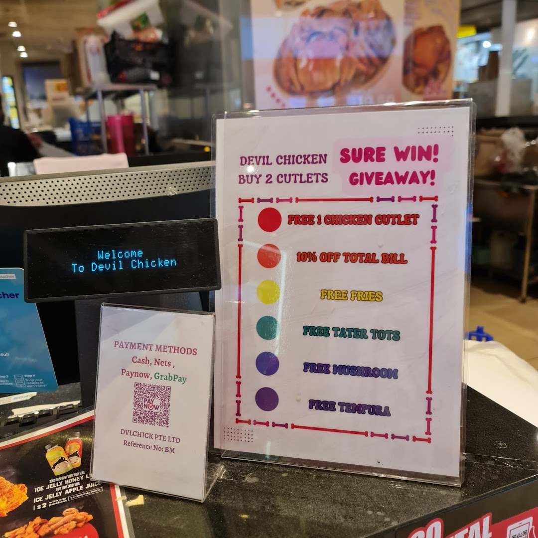 Shop counter with promotional giveaway sign and payment methods.
