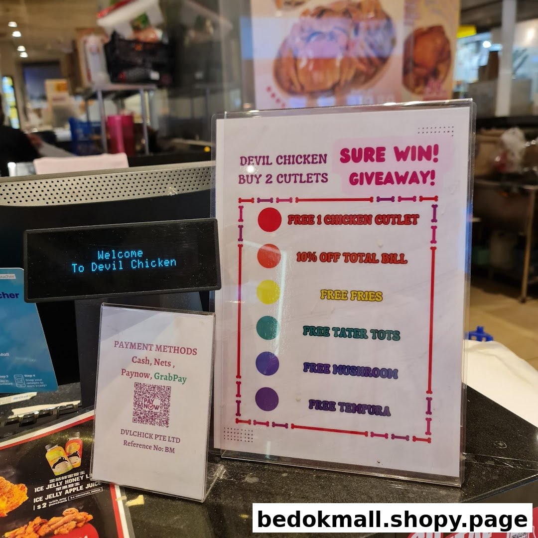 Shop counter with promotional giveaway sign and payment methods.