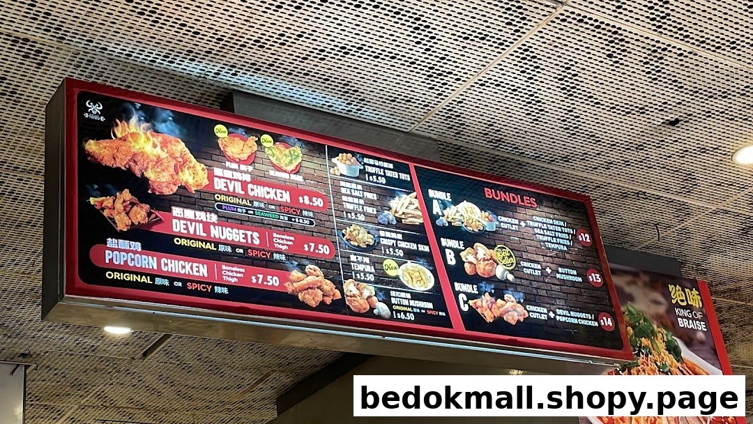A brightly lit menu board displaying various fried chicken items, sides, and meal bundles.