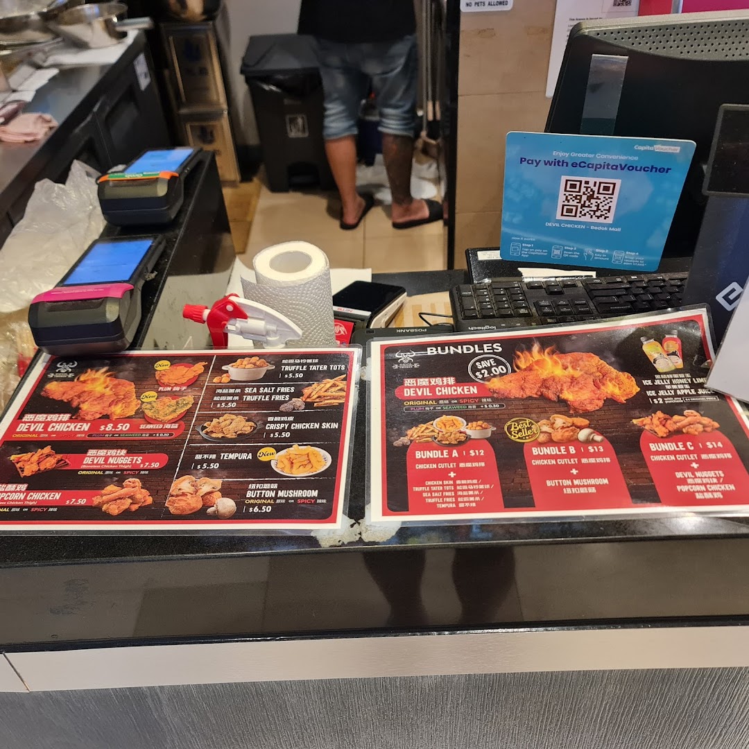 A shop counter with payment terminals, a POS system, and food menus.