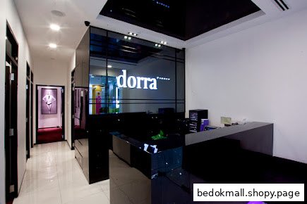 Interior view of a modern shop reception area with a counter and hallway.
