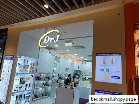 Shop entrance with Dr J sign, display panels, and visible interior.