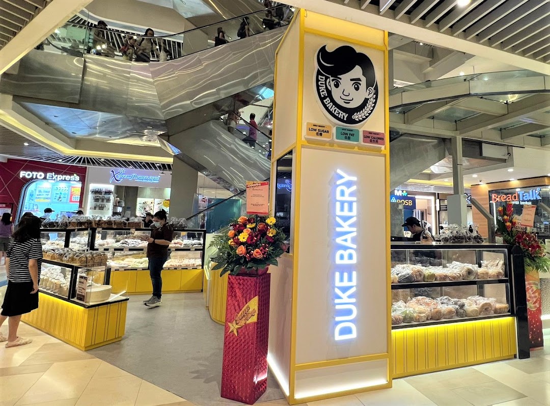 Interior view of Duke Bakery kiosk in a mall, displaying baked goods.