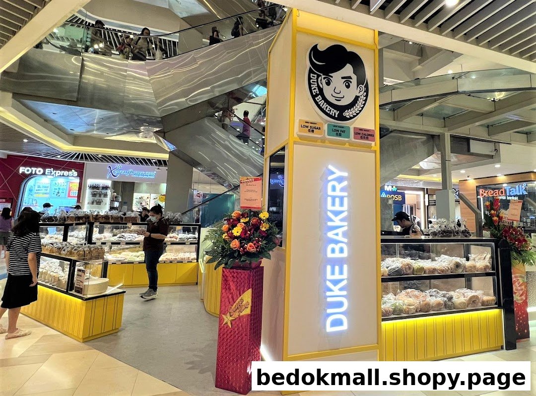 Interior view of Duke Bakery kiosk in a mall, displaying baked goods.
