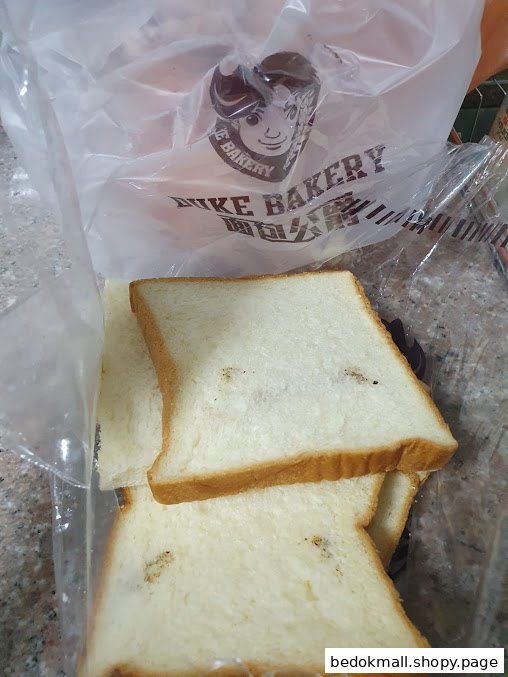 Sliced bread in a plastic bag with Duke Bakery branding.