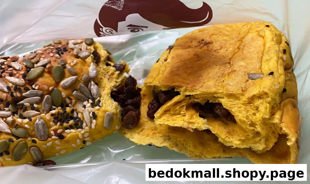 Two pieces of bread, one with seeds and one with raisins, in a plastic bag.