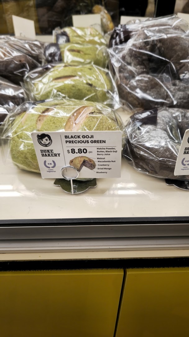 Packaged bread items displayed in a bakery case with a price tag.