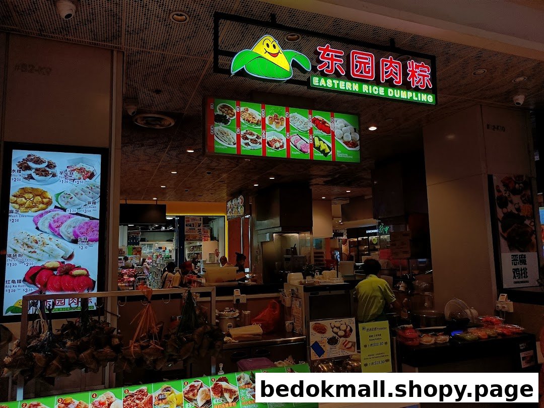 Interior view of a food stall counter with products, staff, and menus.