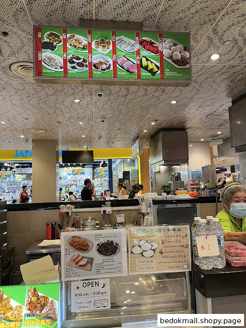 Interior view of a food stall counter with overhead and counter menus.