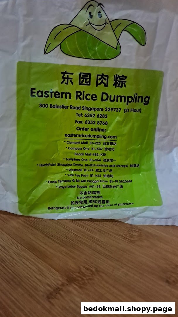 White bag with green label displaying business name, contact details, and branch locations.