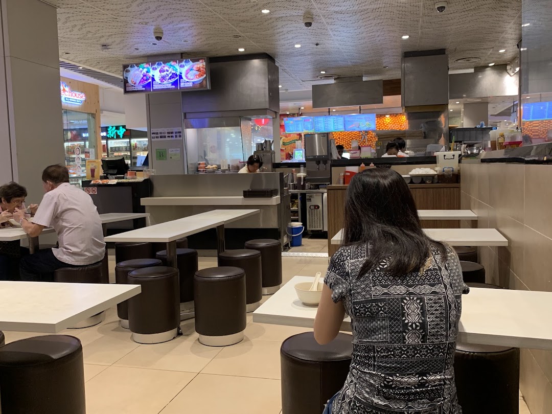 Customers dining at tables in a casual restaurant setting.