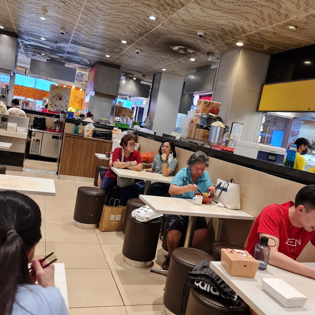 Customers eating at tables in a casual dining area or food court.