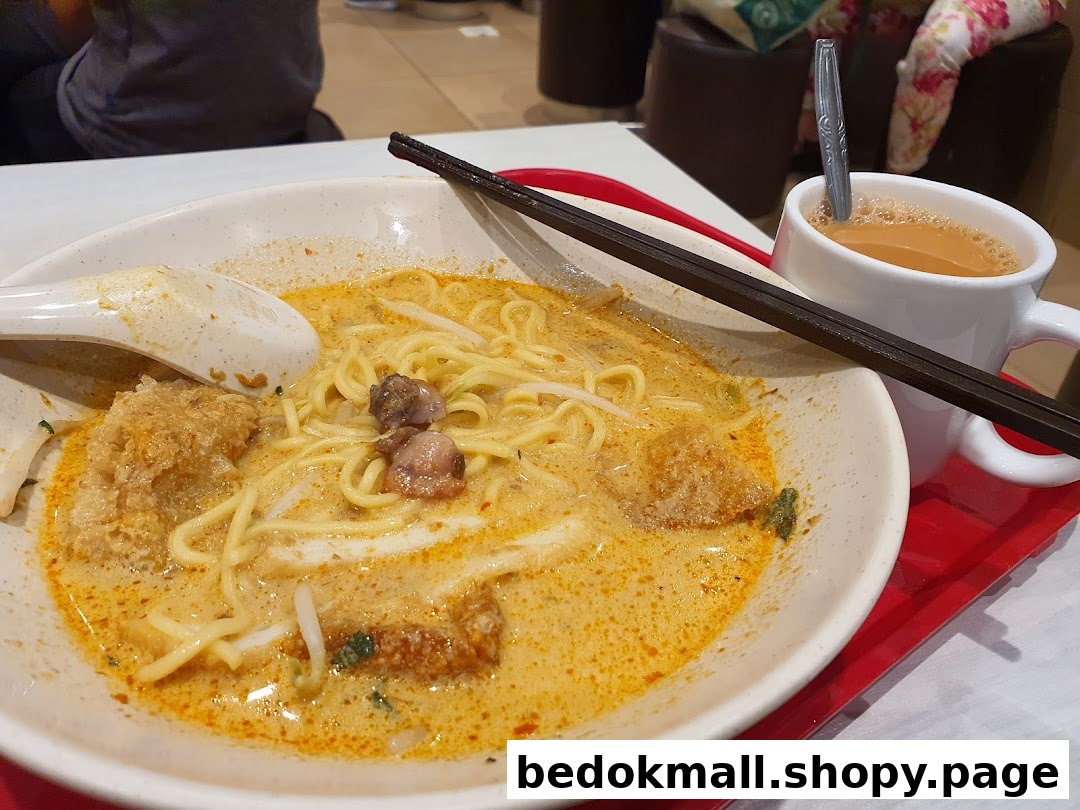 A bowl of noodles and a cup of drink on a red tray.