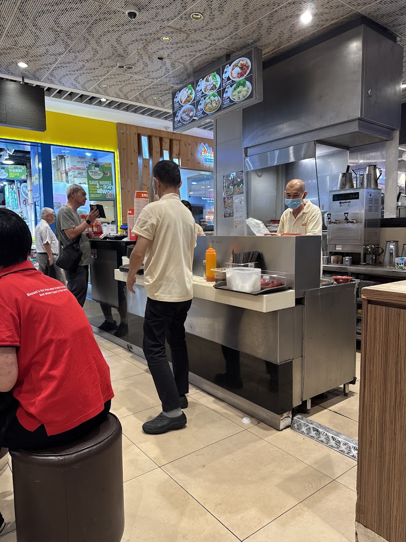 Interior view of a food stall with customers and staff.