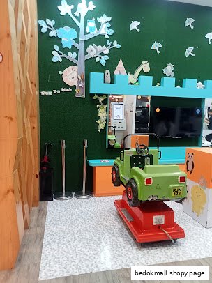 Shop interior with a children's ride-on jeep and cartoon wall decorations.