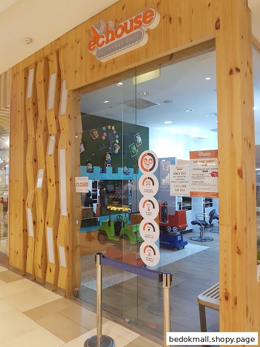 Exterior view of EC House, a children's hair salon with toy vehicle chairs.