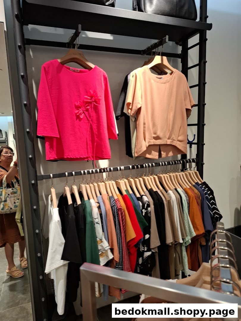 Clothing racks with various garments displayed inside a retail shop.