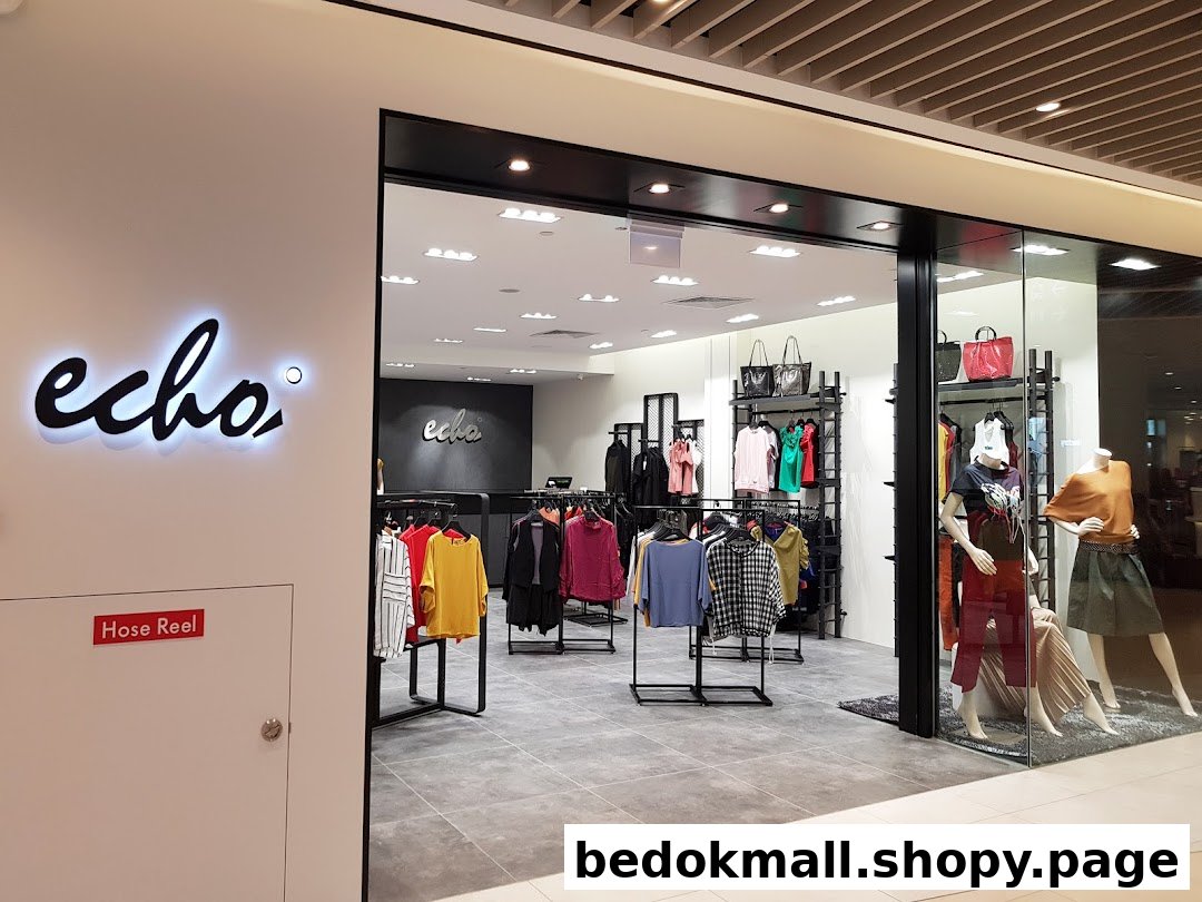 Entrance of a clothing store with mannequins and clothes racks visible inside.
