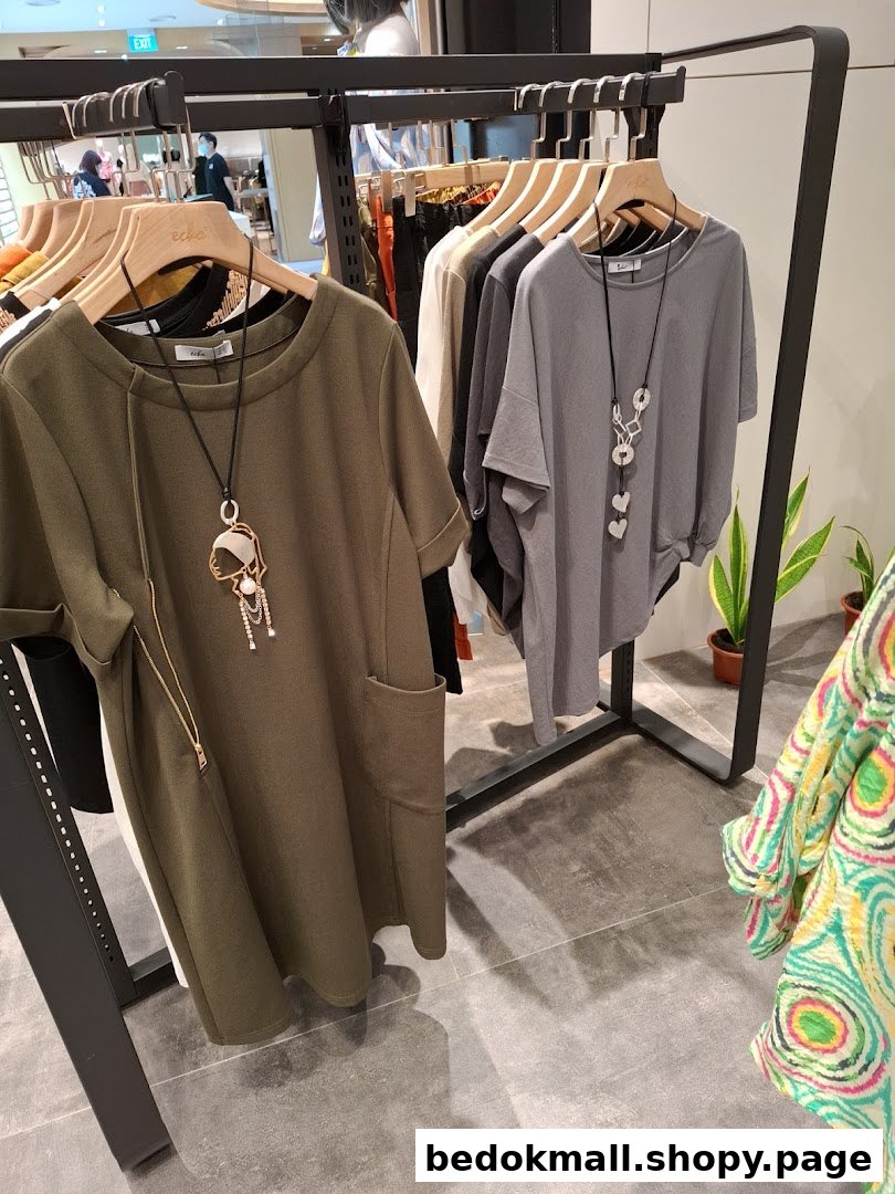 Clothing items on hangers displayed on a rack inside a shop.