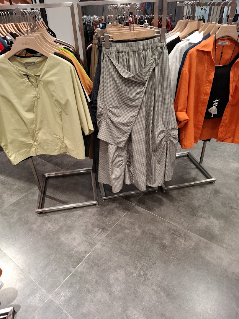 Clothing items displayed on racks inside a retail store.